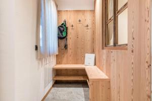 a tiny house with a bench in the corner at Guntschöllerhof Hochwart in Völs am Schlern +21 photos