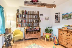 a room with a book shelf filled with books at Guntschöllerhof Hochwart in Völs am Schlern