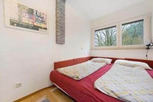 two beds in a room with two windows at Ferienwohnung Dittmar am Kaffeehof in Bad Liebenzell