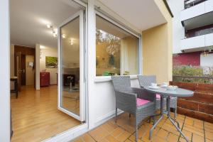 a patio with a table and chairs and a window at Ferienwohnung Dittmar am Kaffeehof in Bad Liebenzell