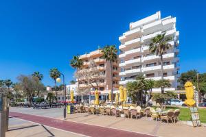 a street with tables and chairs and a building at Mastil in Cala Millor