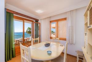 a dining room with a table and a view of the ocean at Mastil in Cala Millor