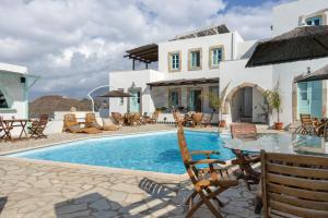 a villa with a swimming pool and a house at Santanna Suites in Patmos