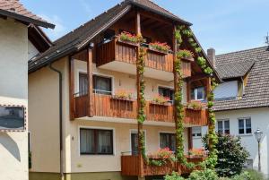 a building with flower boxes on the balconies at Ferienwohnungen Kopp in Hagnau