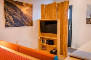 a living room with a flat screen tv on a wall at Wohnplatz 52 in Inzigkofen