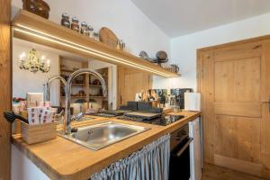 a kitchen with a sink and a stove at Ferienappartement 2 - Lockstein in Berchtesgaden +13 photos
