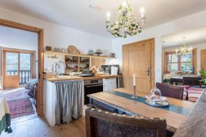 a kitchen with a table and a chandelier at Ferienappartement 2 - Lockstein in Berchtesgaden