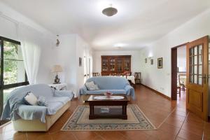 a living room with a couch and a table at Casa da Alfarrobeira in Loulé +19 photos