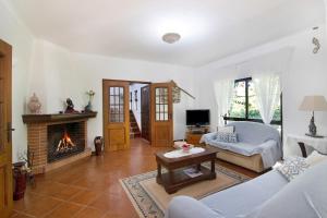 a living room with a couch and a fireplace at Casa da Alfarrobeira in Loulé