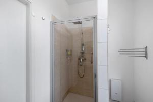 a shower with a glass door in a bathroom at 'kiek In' Fewo Schellberg in Grevesmühlen +17 photos