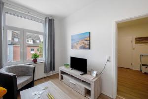 a living room with a flat screen tv on a table at 'kiek In' Fewo Schellberg in Grevesmühlen