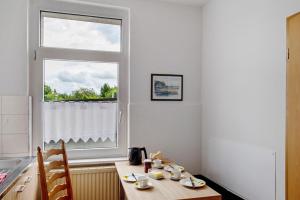 a kitchen with a wooden table and a window at 'kiek In' Fewo Schellberg in Grevesmühlen
