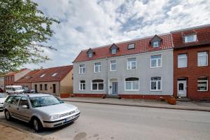 a silver car parked in front of a house at 'kiek In' Fewo Schellberg in Grevesmühlen