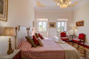a bedroom with a large bed with red pillows at Villa Oliva Al in Moncarapacho +43 photos