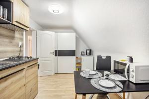 a small kitchen with a table and a microwave at Haus Falk in Zarpen