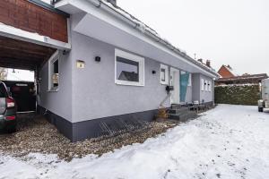 a house with snow on the ground in front of it at Haus Falk in Zarpen