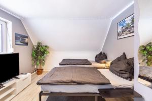 a room with two beds and a flat screen tv at Haus Falk in Zarpen