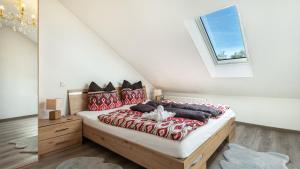 a bedroom with a large bed with red pillows at Fuchswiese in Thurmansbang