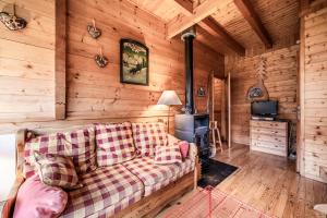 a living room with a couch and a stove at La Rissole - Chalet familial in Châtel