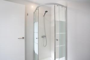 a shower with a glass door in a bathroom at Casa Judit in Los Silos +27 photos
