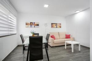 a living room with a table and a couch at Casa Judit in Los Silos