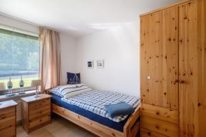 a small bedroom with a bed and a window at An der Silberfuchsbörse in Wurster Nordseeküste