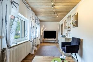 a living room with a radiator and a television at Ferienwohnung Jesteburg in Jesteburg