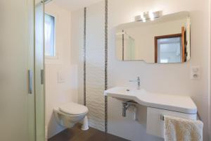 a bathroom with a toilet and a sink and a mirror at Bellevue rue de la petite corniche in Perros-Guirec +19 photos