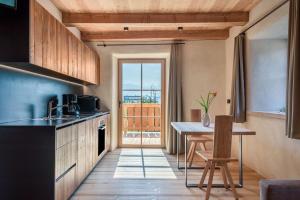 a kitchen with a table and a dining room at Egger an der Lahn - Apt Dolomiten in San Genesio Atesino
