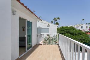 a balcony of a white house with a white railing at Villa Maria Maspalomas Gran Canaria in Maspalomas