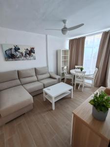 a living room with a couch and a table at Villa Maria Maspalomas Gran Canaria in Maspalomas