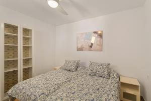 a bedroom with a bed and a painting on the wall at Villa Maria Maspalomas Gran Canaria in Maspalomas +32 photos
