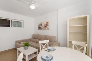 a living room with a couch and a table at Villa Maria Maspalomas Gran Canaria in Maspalomas