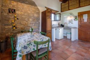 a kitchen and dining room with a table and chairs at Stella Nord Podere Carbone in Grosseto