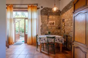 a dining room with a table and a stone wall at Stella Nord Podere Carbone in Grosseto