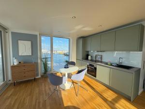 a kitchen with a table and chairs in a room at Floating Home Nr 1 in Laboe