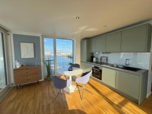 a kitchen with a table and chairs in a room at Floating Home Nr 1 in Laboe