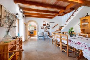 a kitchen and dining room with a table and chairs at Can noble den suau in Pollença