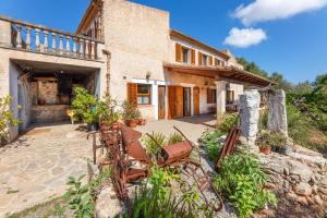 an exterior view of a house with a patio at Can noble den suau in Pollença