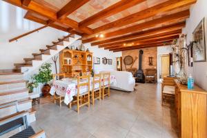 a living room with a table and a bedroom at Can noble den suau in Pollença