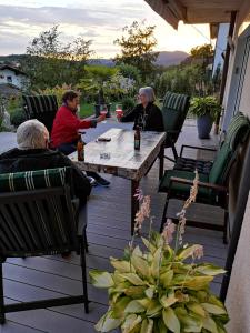 a group of people sitting at a table on a patio at Ferienwohnung Anita Benz in Thurmansbang