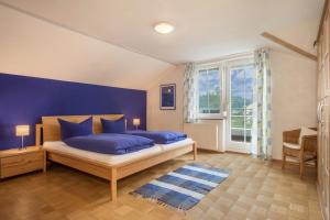 a bedroom with two blue pillows on a bed at Ferienwohnung Schleinseeblick in Kressbronn am Bodensee