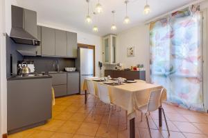 a kitchen and dining room with a table and chairs at Residence Franciacorta in Rovato