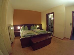 a bedroom with a bed with a wooden head board at Landhaus Breitenberg in Bad Hofgastein