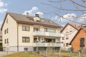 a white house with a black roof at Ferienwohnung Maria Feucht in Überlingen