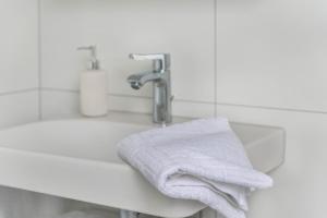 a white towel sitting on a sink next to a faucet at Ferienwohnung Maria Feucht in Überlingen +17 photos