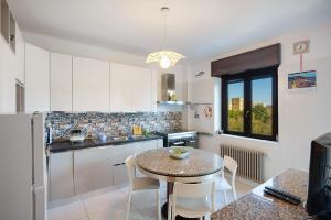 a kitchen with a table and a small table and chairs at Casa Isabea in Pozzuoli