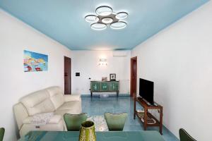 a living room with a couch and a tv at Casa Isabea in Pozzuoli