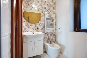 a bathroom with a sink and a toilet at Casa Isabea in Pozzuoli +33 photos