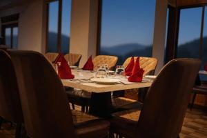 a dining table with red napkins on top of it at Norbu Lingka Resort in Tongsa +2 photos
